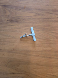 Earthle earthing splitter on a wooden floor, with the press stud connections visible