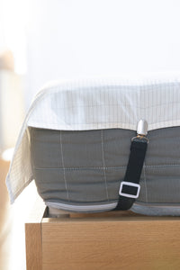Close-up of the clip of an Earthle sheet strap on the edge of the earthing sheet