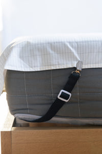 Earthle sheet strap running diagonally under the mattress corner, with the earthing sheet over it